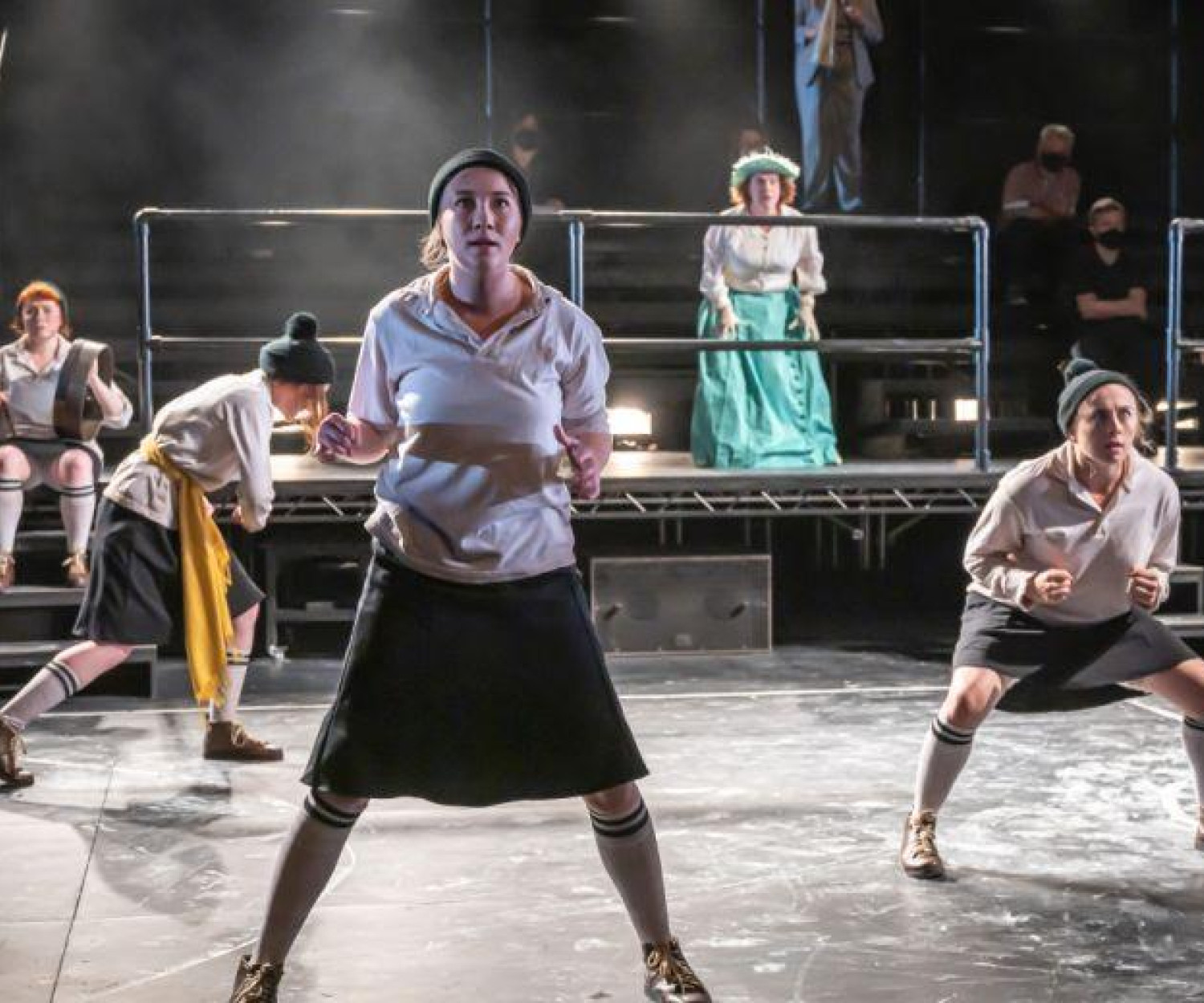 Dance group performing on stage.