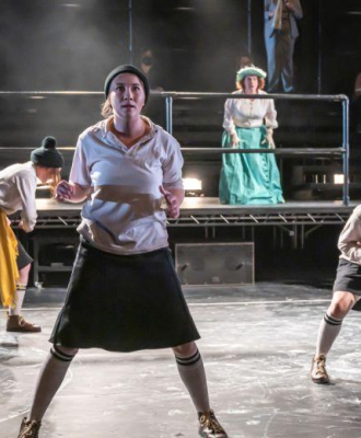 Dance group performing on stage.