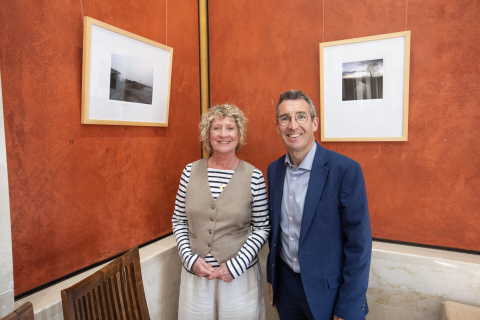 man and woman standing in front of a print artwork