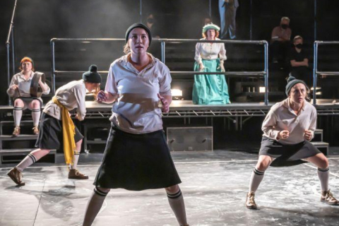 Dance group performing on stage.