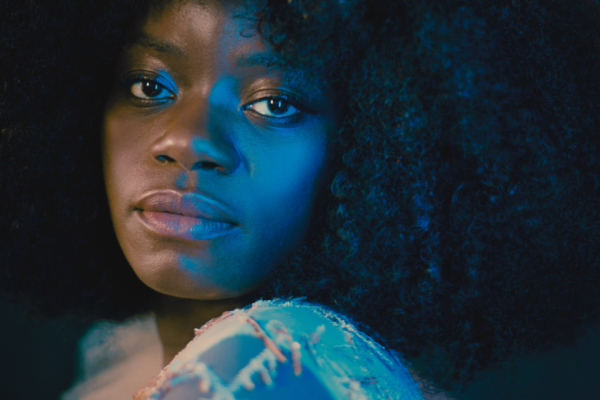 Close up shot of young woman, looking over her shoulder, making a pensive expression