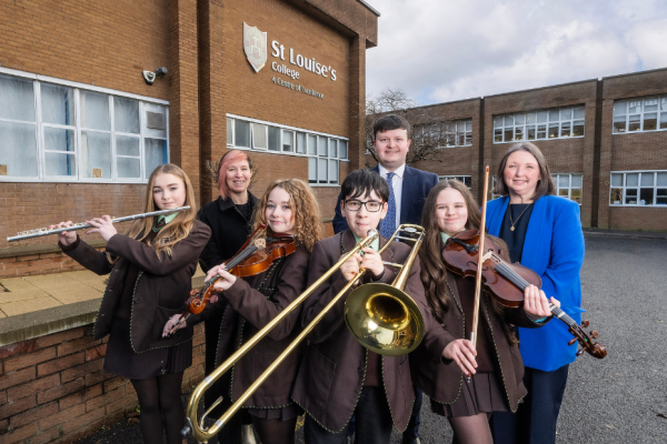 A group of school pupils holding musical instruments