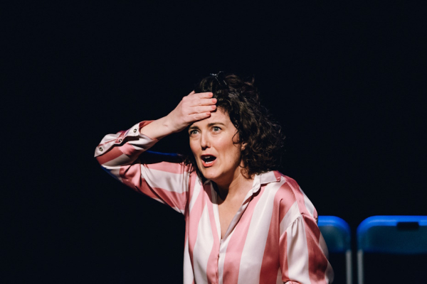 An image of a women with her mouth wide open and hand on her forehead