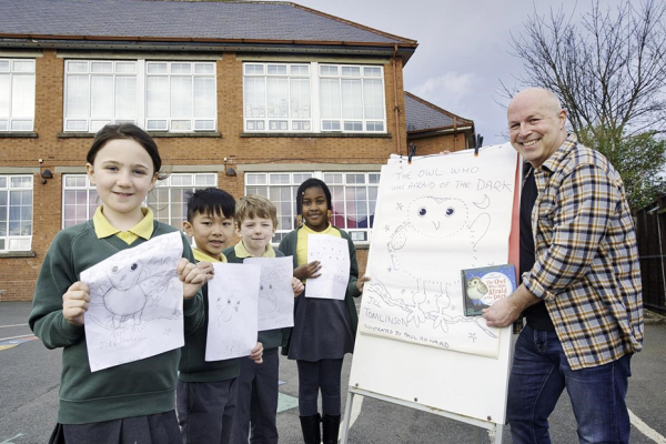 Rosetta Primary School pupils in the school yard holding their drawings with Children’s Writing Fellow Paul Howard.
