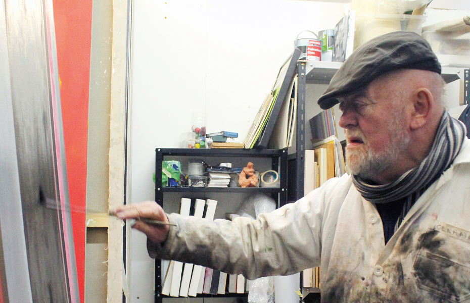 A photo of Ray Duncan, painting on a canvas.