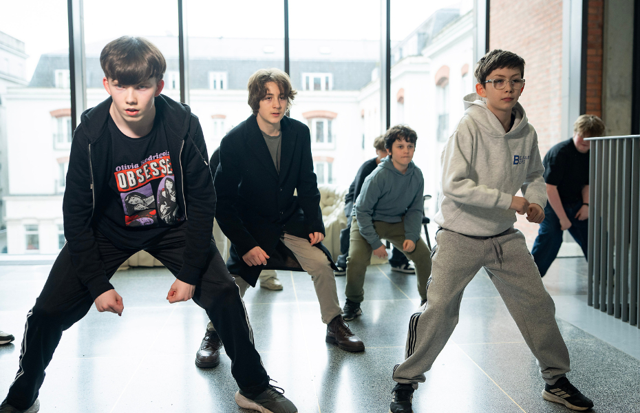 Teenage boys dancing inside the MAC.