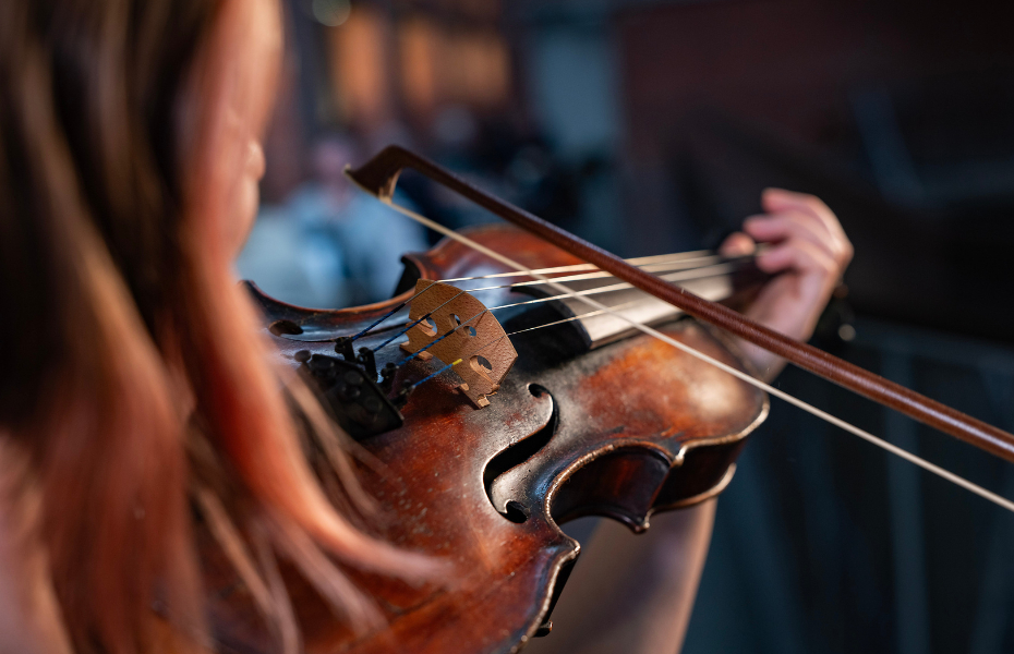 Close-up of female playing a fiddle