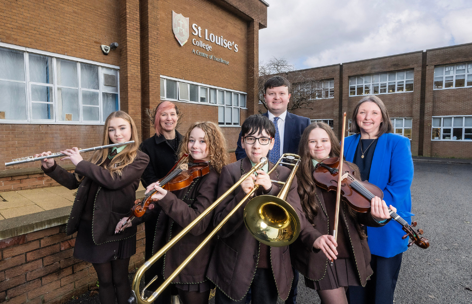 A group of school pupils holding musical instruments