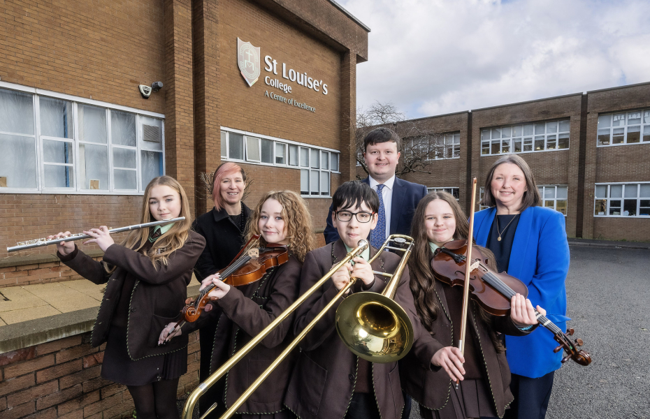 St Louise's student and staff are pictured outside the school with some of their new instruments