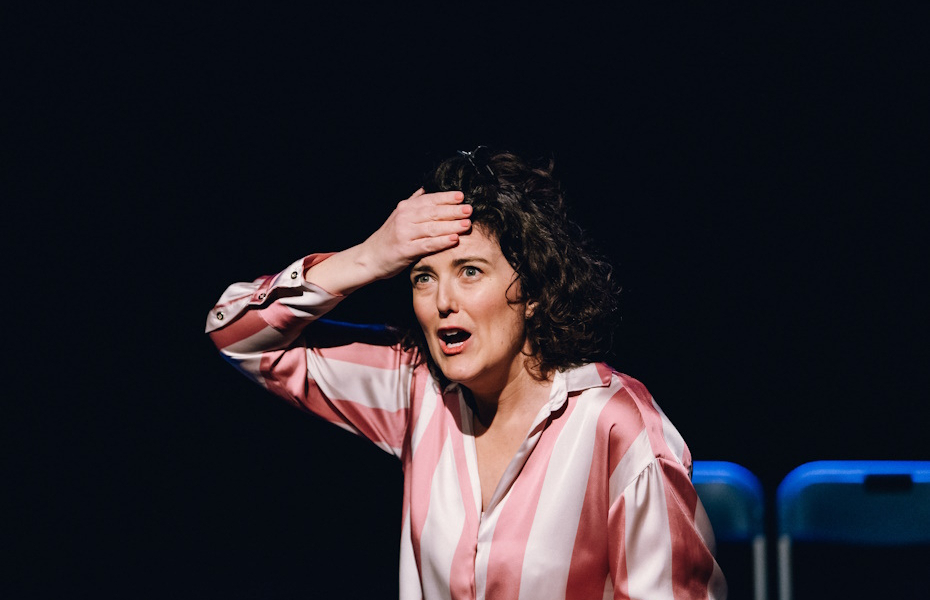 An image of a women with her mouth wide open and hand on her forehead