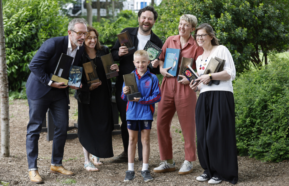 Kilkenny schoolboy celebrates ‘Reading Hero’ win with KPMG Children’s Books Ireland Book Awards winners in a group photo.