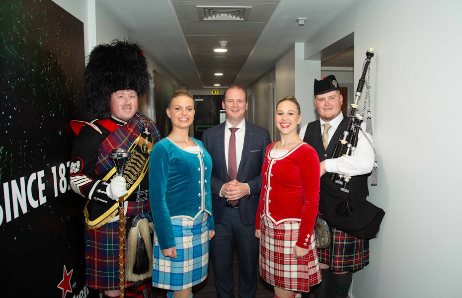 Picture of the Minister pictured with band members, with instruments and in traditional scottish kilts