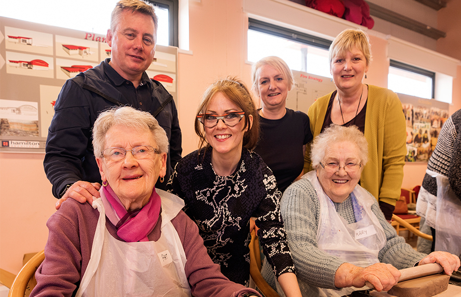 Participants from the Heart of the Sperrins Arts and Older People Programme supported project enjoying a clay workshop with artist Leona Devine.