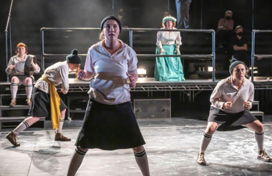 Dance group performing on stage.