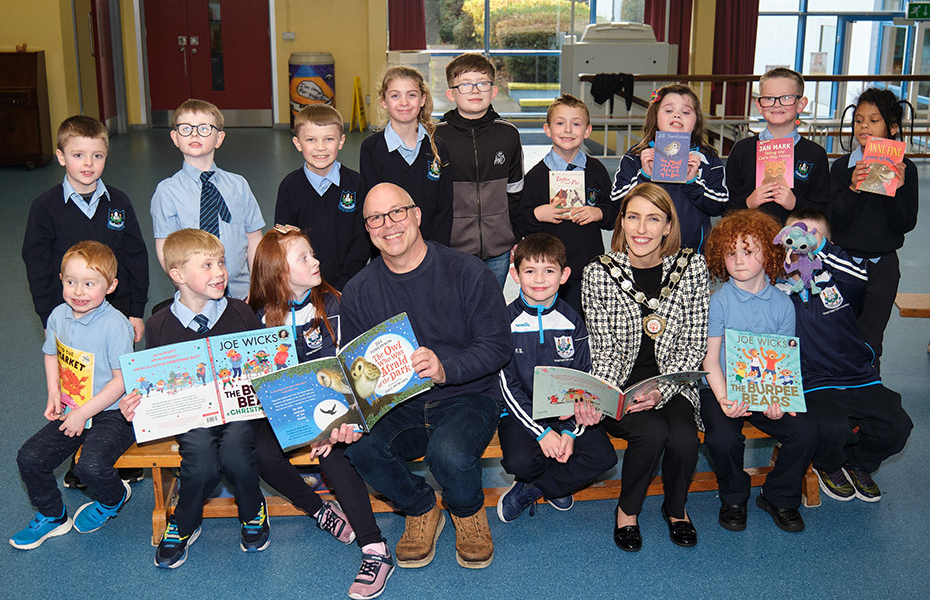 Children’s Writing Fellow Paul Howard with pupils from St Mary’s Primary School in Maghera and Mid Ulster District Council Chair, Cora Corry.