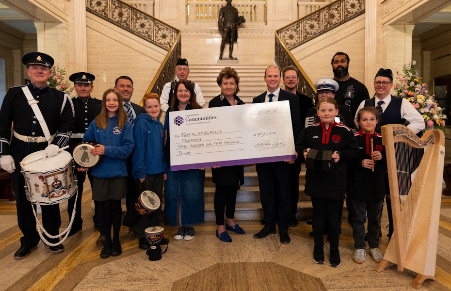 Pictured in front of the steps inside Stormont Buildings a large group of musicans gather, along with the Communities Minister and representatives from the Arts Council