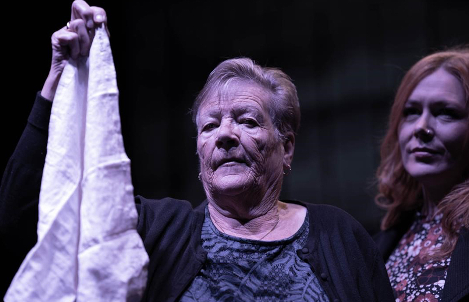 Female actress holding White Handkerchief during a performance at the Playhouse Derry-Londonderry.
