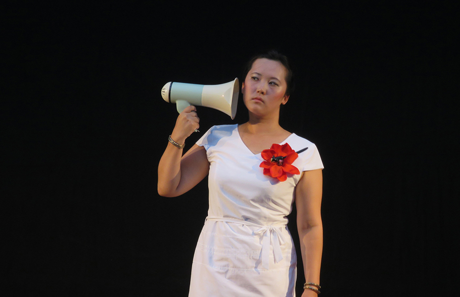 Sound artist Una Lee during a performance holding a megaphone.